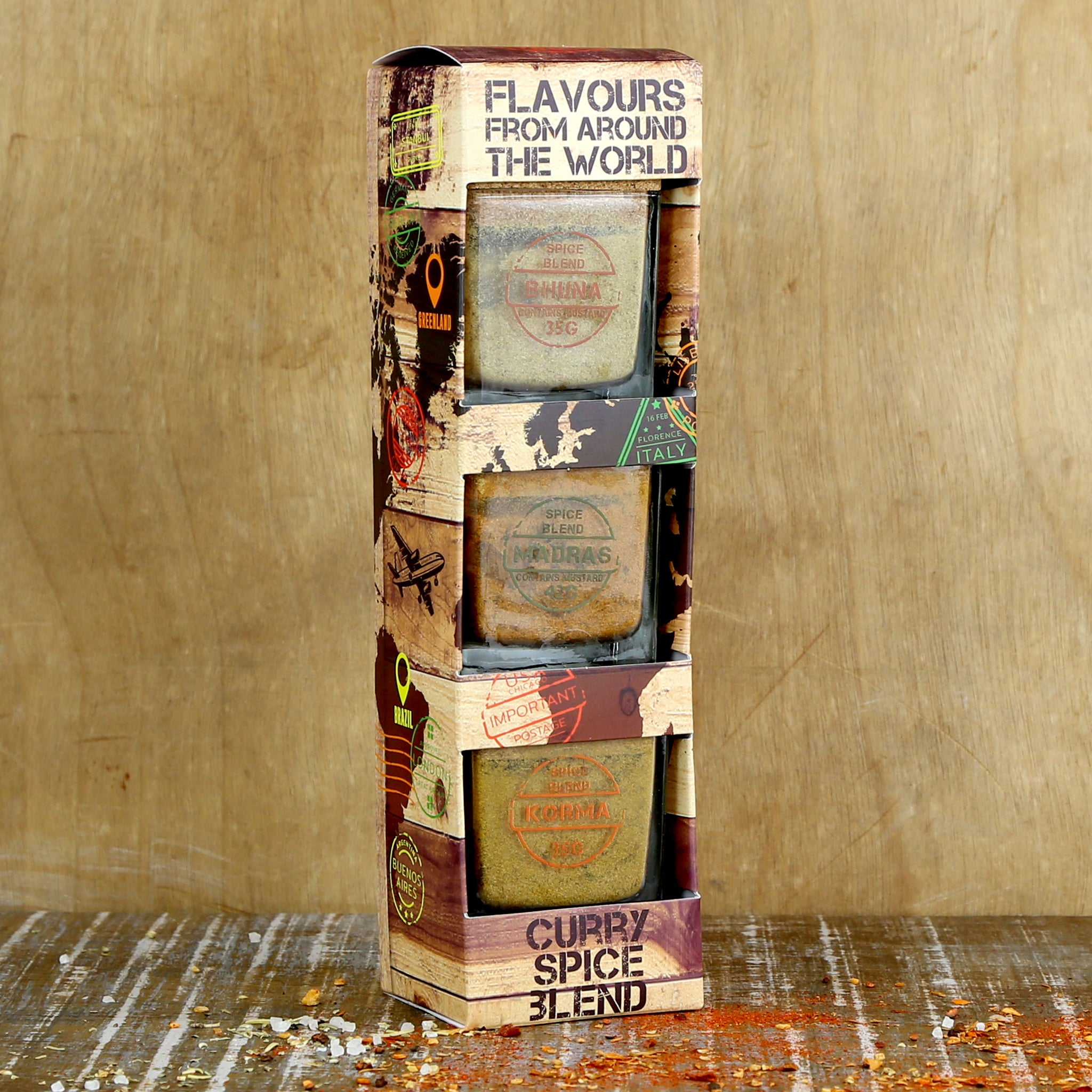 3 curry spice blend seasonings in glass pots displayed stacked in printed packaging