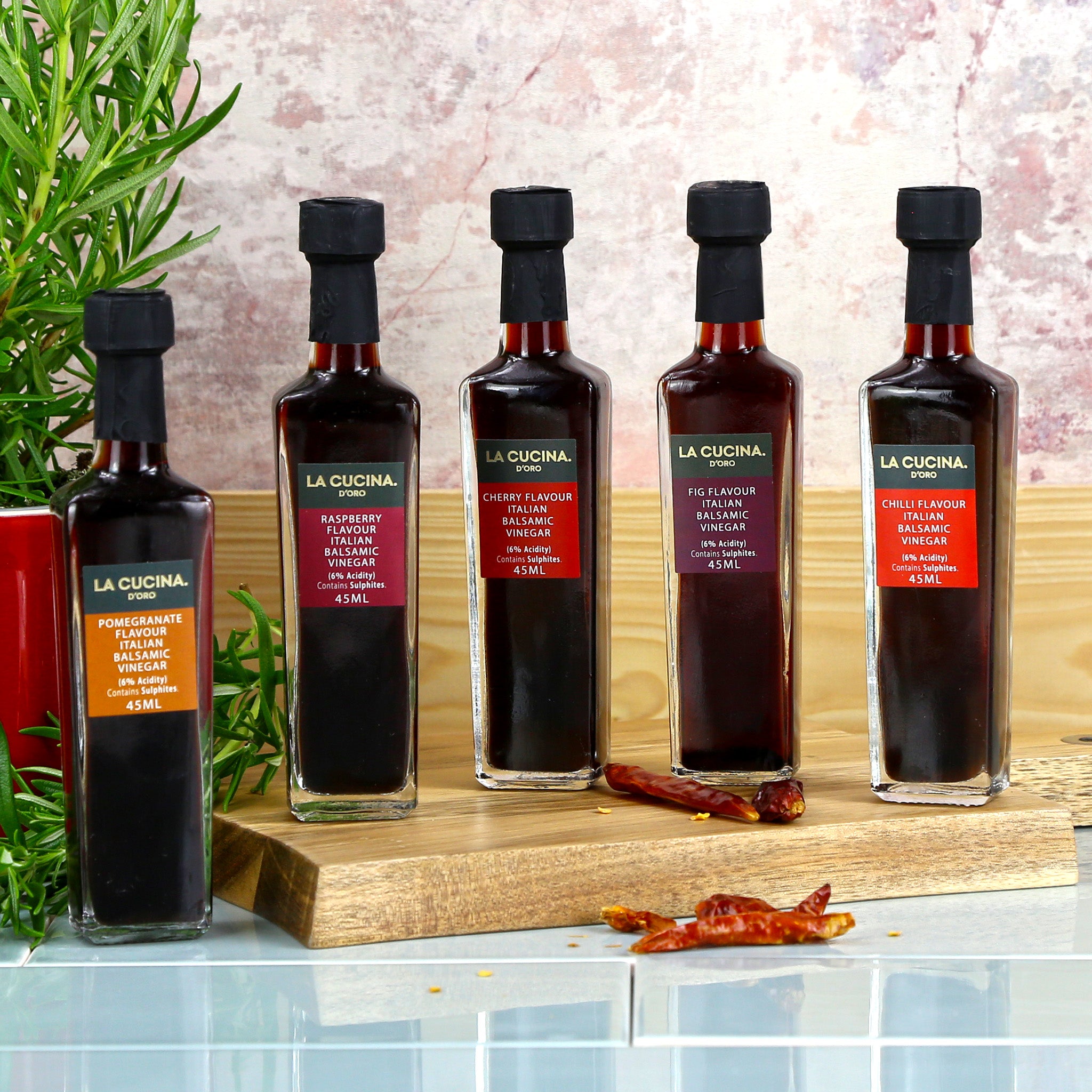 A selection of five flavoured balsamic vinegars in glass bottles