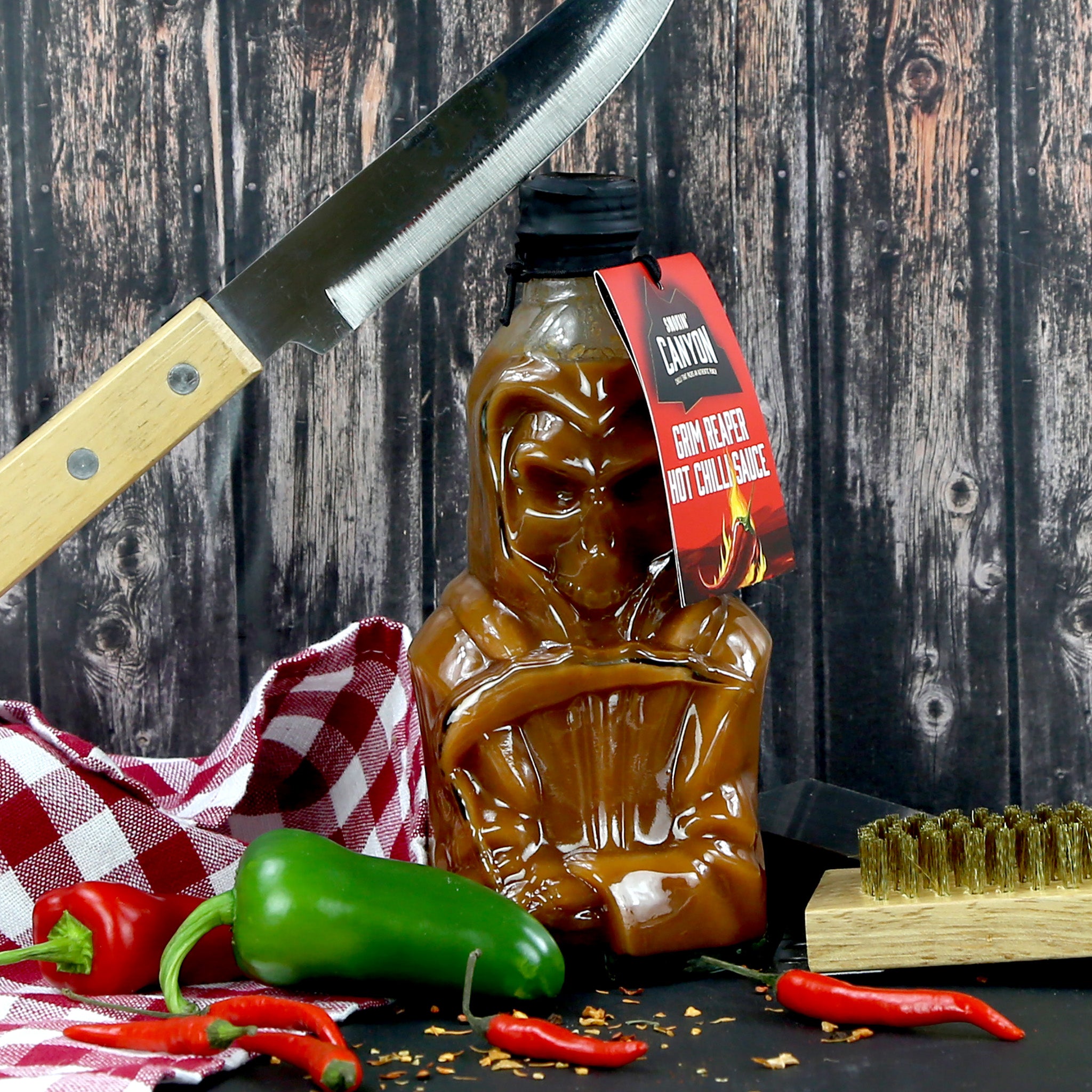 Fiery hot sauce presented in a glass bottle shaped like the Grim Reaper