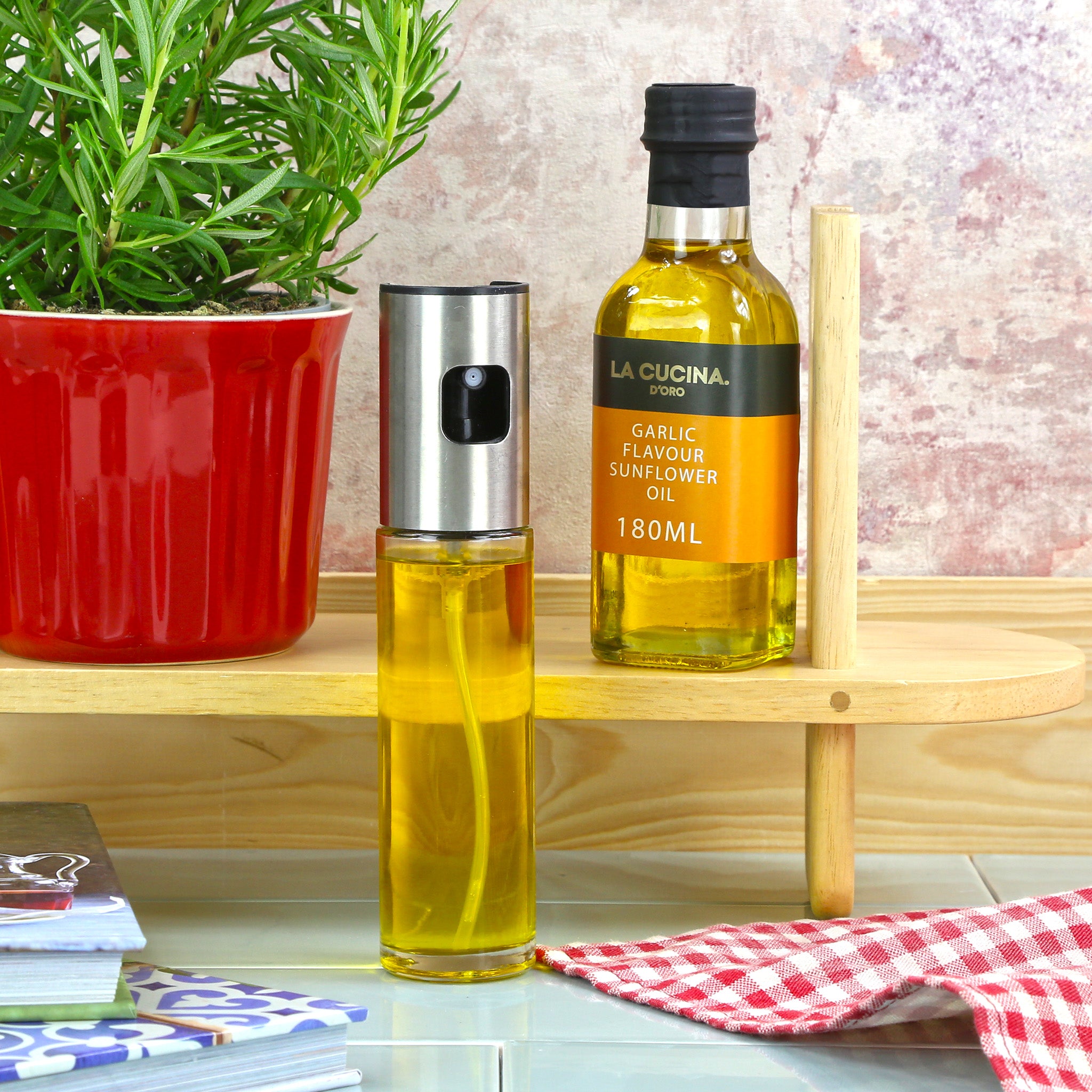 An oil spritzer bottle with a bottle of garlic oil